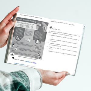 A person holding cat grooming 101 cat book Looking_inside_by_Toe_Beans